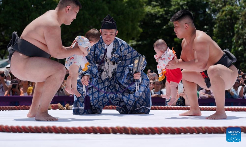Sumo wrestlers hold children during the Naki Sumo Crying Baby Contest in Tokyo, Japan, on April 28, 2024. Naki Sumo is a traditional ceremony performed as a prayer for healthy growth.(Photo: Xinhua)