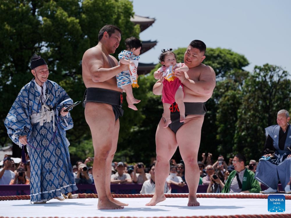 Sumo wrestlers hold children during the Naki Sumo Crying Baby Contest in Tokyo, Japan, on April 28, 2024. Naki Sumo is a traditional ceremony performed as a prayer for healthy growth.(Photo: Xinhua)