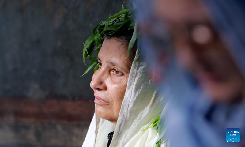 An Orthodox believer attends a religious service at the Patriarchal Cathedral after the Palm Sunday procession in Bucharest, Romania, April 27, 2024. Hundreds of Orthodox priests and believers walked through Romania's capital to celebrate the upcoming Orthodox Palm Sunday.(Photo: Xinhua)