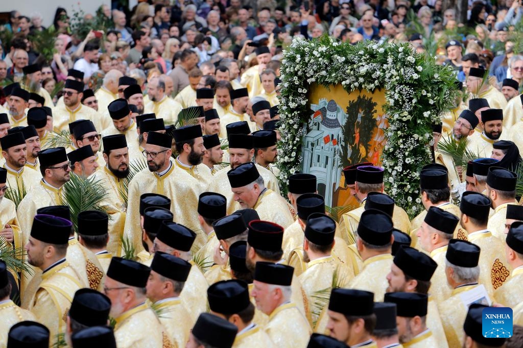 Orthodox priests attend a religious service at the Patriarchal Cathedral after the Palm Sunday procession in Bucharest, Romania, April 27, 2024. Hundreds of Orthodox priests and believers walked through Romania's capital to celebrate the upcoming Orthodox Palm Sunday.(Photo: Xinhua)
