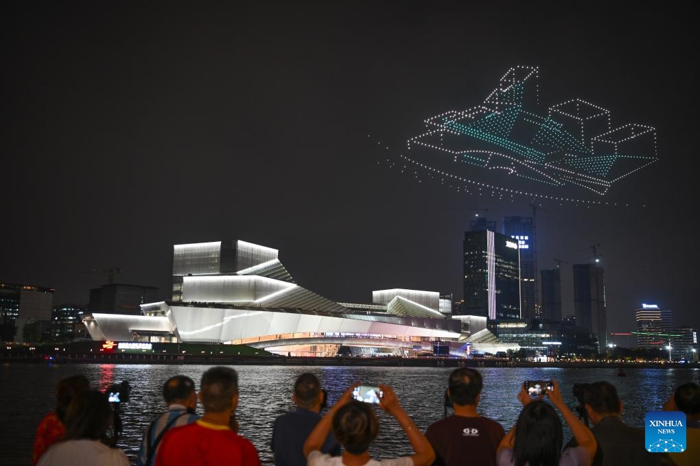 A drone show is staged around the Bai'etan Greater Bay Area Art Center in Guangzhou, south China's Guangdong Province, April 28, 2024. Housing the Guangdong Museum of Art, the Guangdong Intangible Cultural Heritage Exhibition Center, and the Guangdong Literature Hall, the art center was inaugurated on Sunday.(Photo: Xinhua)