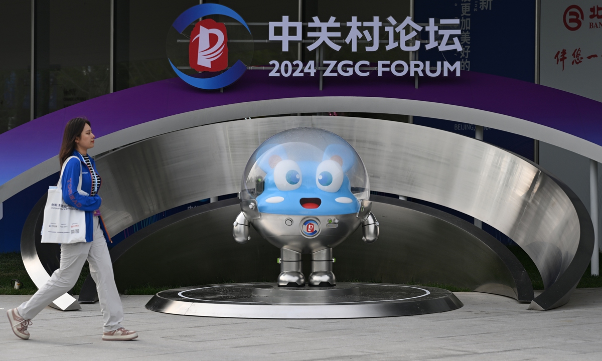 A volunteer walks past a mascot of the 2024 Zhongguancun (ZGC) Forum in Beijing on April 29, 2024 as the tech event closed on Monday. Photo: VCG
