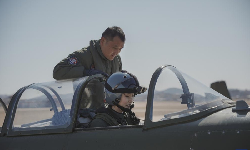 A flight instructor from Naval Aviation University guides a member of the first group of female pilot trainees from the carrier-based aircraft of the Chinese People's Liberation Army Navy in China, March 6, 2024.

The first group of female pilot trainees from the carrier-based aircraft of the Chinese People's Liberation Army Navy has completed their inaugural solo flights, indicating that they are now capable of independently piloting an aircraft and conducting flights.(Photo by Chen Chao/Xinhua)