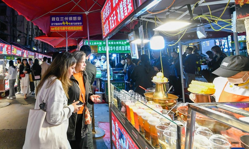 Tourists visit a night market at Chengguan District in Lanzhou, capital of northwest China's Gansu Province. As the May Day holiday is approaching, Lanzhou has continued to promote the development of night economy, releasing new vitality for consumption. (Xinhua/Lang Bingbing)