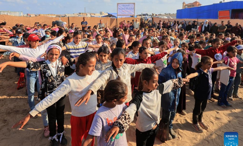Palestinian students take part in outdoor activities at a tent school in the southern Gaza Strip city of Rafah, on April 30, 2024. Now being displaced to the southernmost Gazan city of Rafah, Nihad Badreia, a Palestinian teacher, established a tent school for about 600 school-age children living in a refugee camp, as the current Palestinian-Israeli conflict has deprived students of their studies for nearly seven months.(Photo: Xinhua)