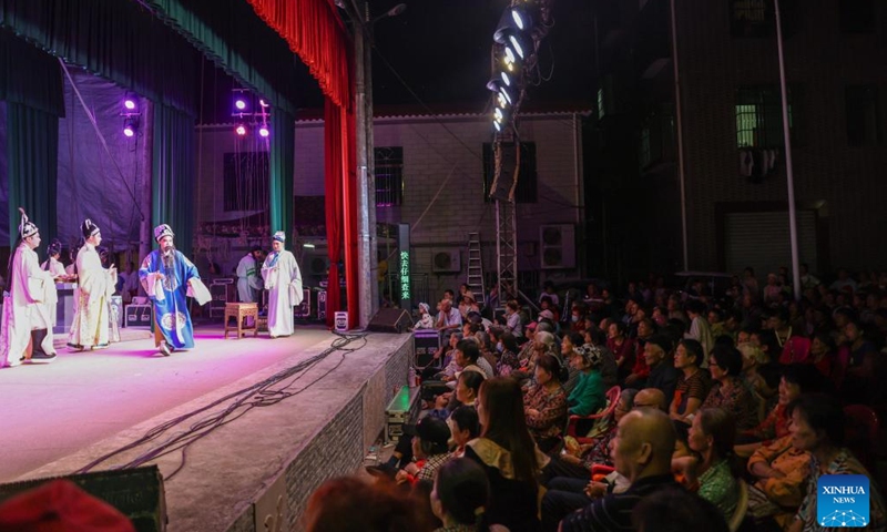 Residents watch a performance of Qiong Opera at Houshan Village, Dingan County, south China's Hainan Province, Feb. 21, 2024. Qiong Opera could be traced back to a century ago in Dingan County in this southern Chinese island, which is referred to as Qiong in abbreviation. (Xinhua/Zhang Liyun)