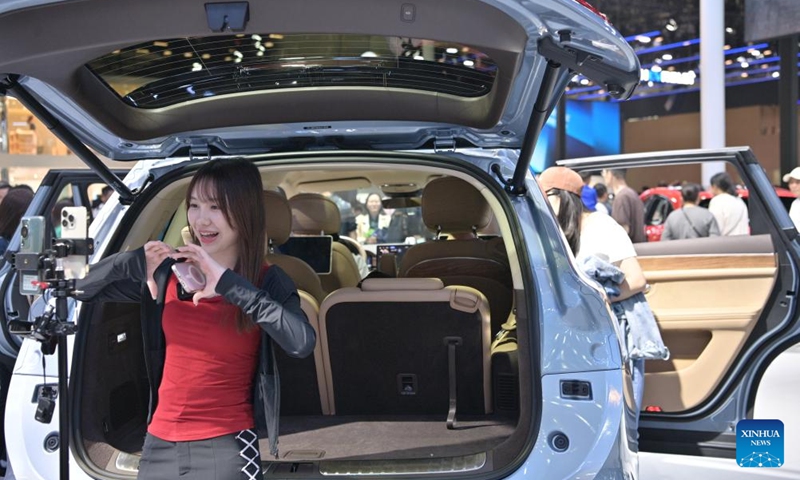 A host presents a vehicle applied with Harmony operating system developed by Huawei during the 2024 Beijing International Automotive Exhibition in Beijing, capital of China, May 4, 2024. The exhibition closed on Saturday. Photo: Xinhua