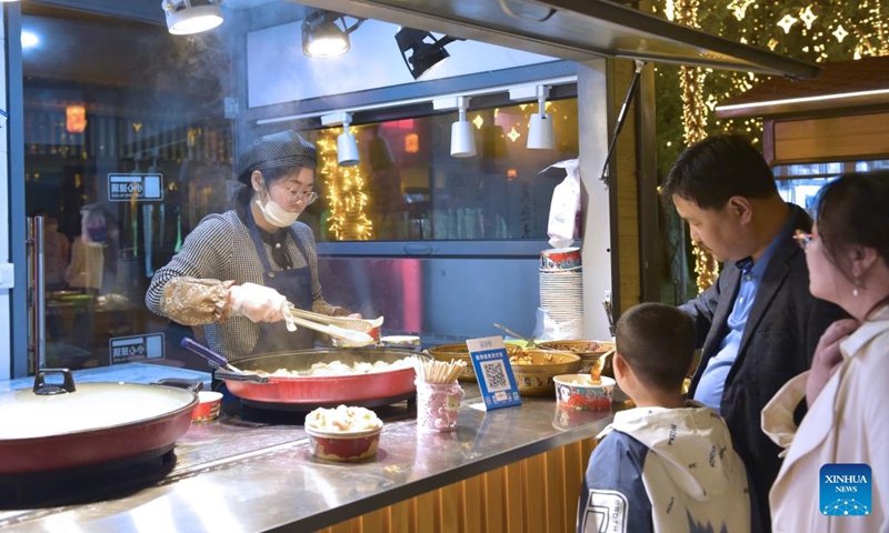 People buy snacks at a cultural compound in Yinchuan City, northwest China's Ningxia Hui Autonomous Region, May 3, 2024. Traffics have surged at tourist attractions throughout the country during the 5-day May Day holiday beginning on May 1. Photo: Xinhua