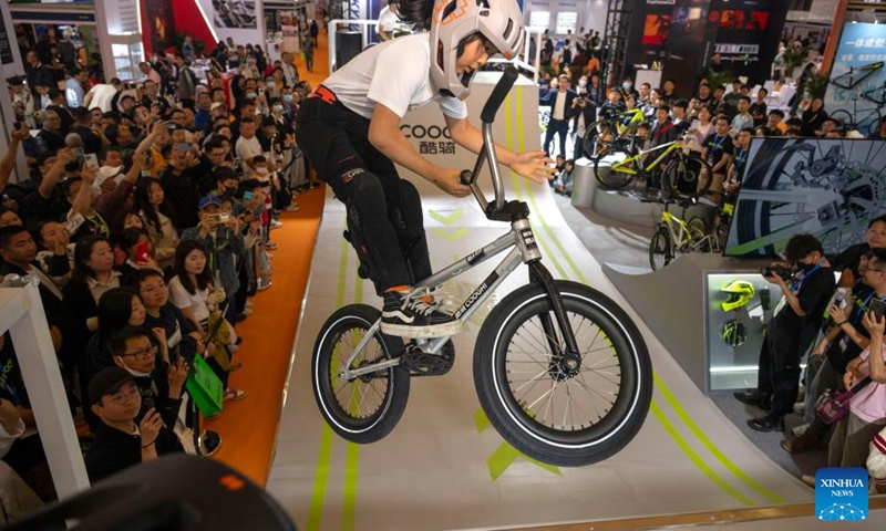 A young athlete performs at the booth of COOGHI during the 32nd China International Bicycle Fair in east China's Shanghai, May 5, 2024. The event kicked off here on Sunday, drawing about 1,460 enterprises to participate. Photo: Xinhua