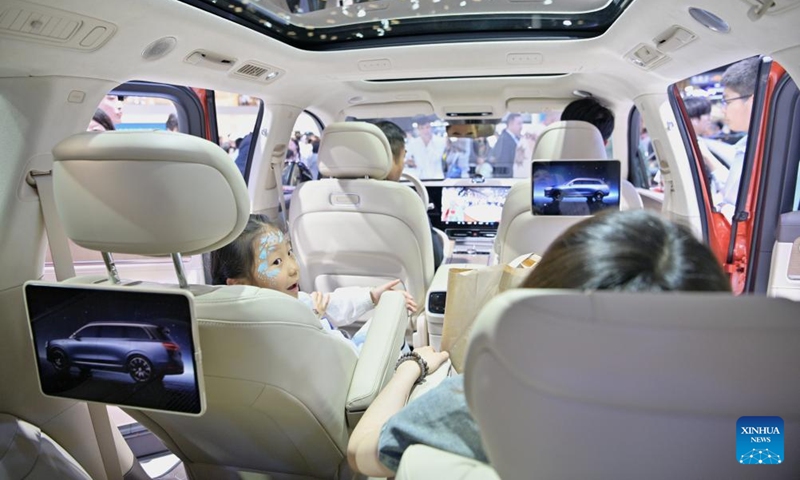 Visitors sit in a vehicle applied with Harmony operating system developed by Huawei during the 2024 Beijing International Automotive Exhibition in Beijing, capital of China, May 4, 2024. The exhibition closed on Saturday. Photo: Xinhua