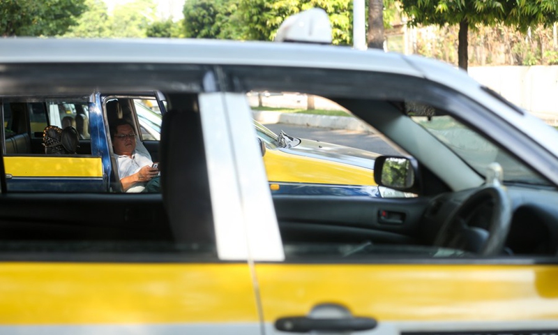 A taxi driver rests inside his car on a hot day in Yangon, Myanmar, May 4, 2024. Photo: Xinhua