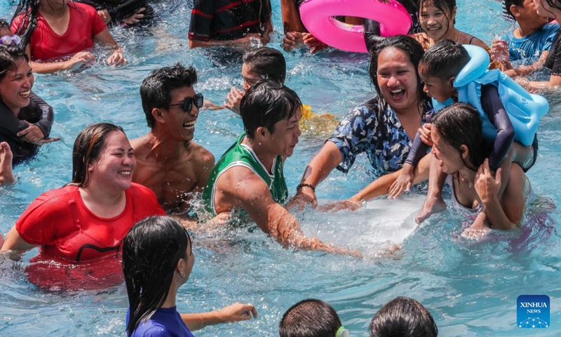 People cool off with ice blocks in a swimming pool at a resort in Bulacan Province, the Philippines, on May 5, 2024. People spend time at pools to cool off amid heatwave in the Philippines. Photo: Xinhua