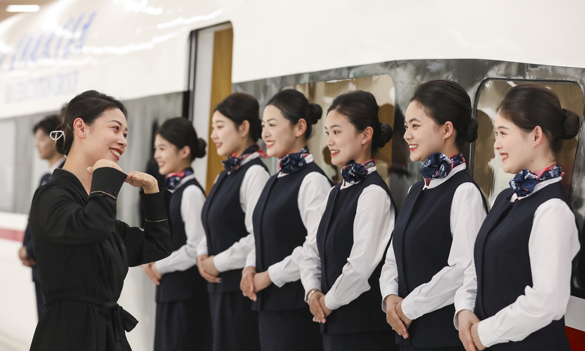 Students from a vocational training college in East China's Jiangsu Province practice smiling as part of their training to become bullet train attendants on May 7, 2024, one day before the World Smile Day. China created 3.03 million new jobs in the first quarter of 2024, signaling a good start for the country's employment market. Photo: cnsphoto