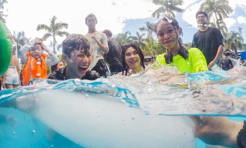 People cool off with ice blocks in a swimming pool at a resort in Bulacan Province, the Philippines, on May 5, 2024. People spend time at pools to cool off amid heatwave in the Philippines. Photo: Xinhua
