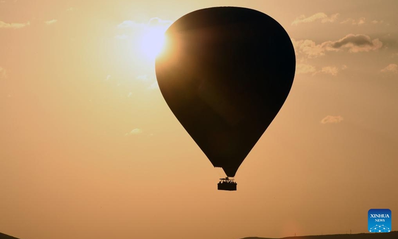 A hot air balloon flies over Cappadocia in Nevsehir, Türkiye on May 5, 2024. (Mustafa Kaya/Handout via Xinhua)