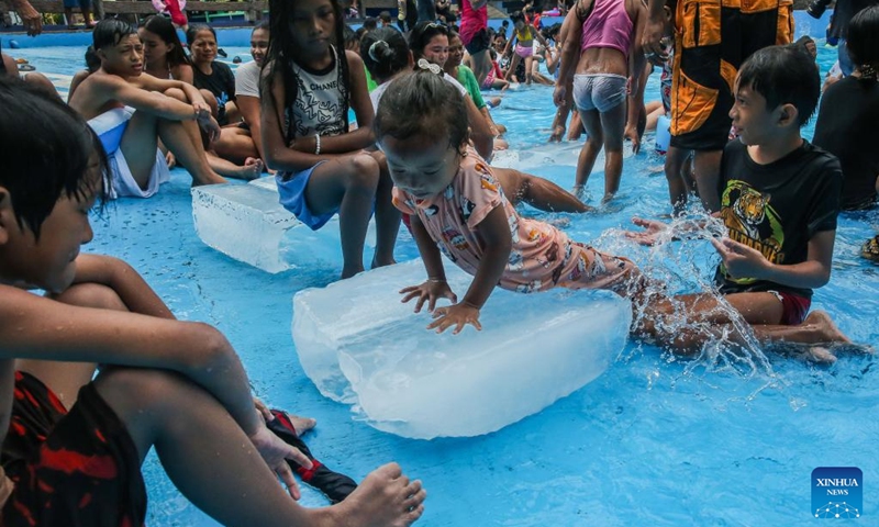 People cool off with ice blocks in a swimming pool at a resort in Bulacan Province, the Philippines, on May 5, 2024. People spend time at pools to cool off amid heatwave in the Philippines. Photo: Xinhua