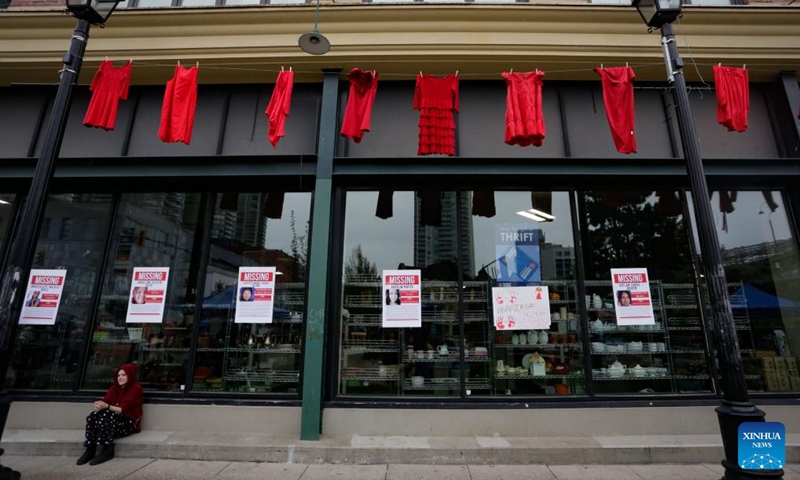 Red dresses are hung outside a building to mark the National Day of Awareness for Missing and Murdered Indigenous Women and Girls on a street in New Westminster, British Columbia, Canada, on May 5, 2024. May 5 is the National Day of Awareness for Missing and Murdered Indigenous Women and Girls, also known as Red Dress Day, in Canada. Photo: Xinhua