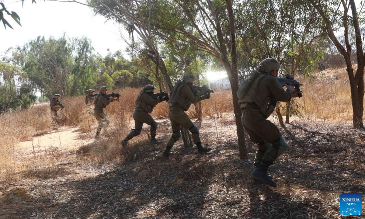 Israeli soldiers take part in a drill before entering Gazan city of Rafah near the Kerem Shalom crossing in Israel, on May 7, 2024. (Photo by Gil Cohen Magen/Xinhua)