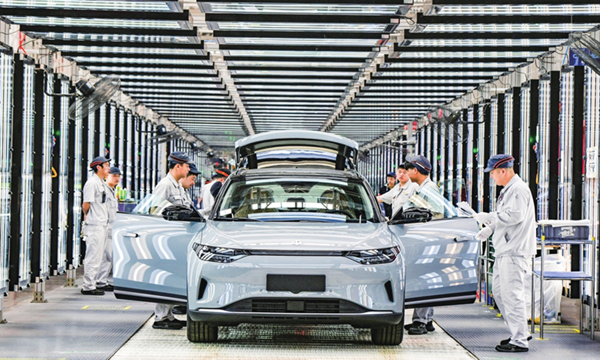 Workers complete assembling an electric vehicle (EV) at China's EV start-up Leapmotor in Jinhua, East China's Zhejiang Province on April 1, 2024. The smart EV factory delivered 14,567 new vehicles in March, a yearly increase of 136 percent. Photo: VCG