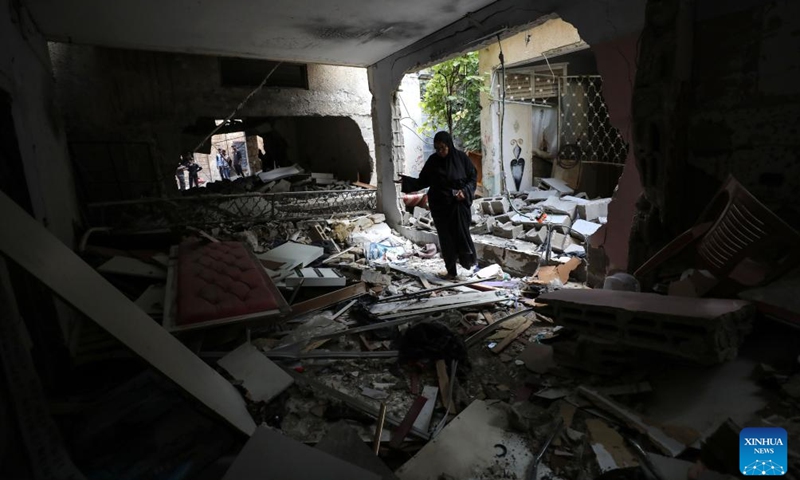 A woman inspects a destroyed house after an Israeli military operation in the city of Tulkarm in the northern West Bank, on May 7, 2024.(Photo: Xinhua)