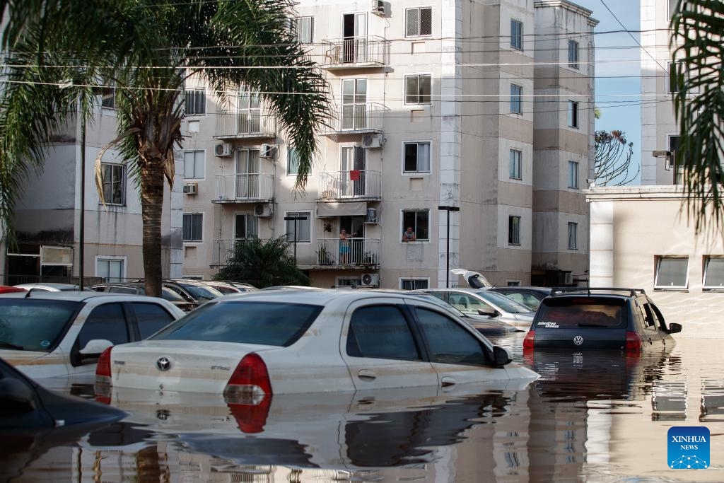 This photo taken on May 7, 2024 shows a view of waterlogged cars and buildings in Scharlau, Sao Leopoldo, in the state of Rio Grande do Sul, Brazil.(Photo: Xinhua)