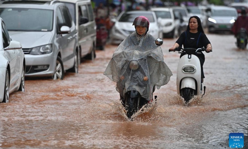 Citizens ride on a flooded street in Nanning, south China's Guangxi Zhuang Autonomous Region, May 8, 2024. Heavy rain hit Nanning on Wednesday.(Photo: Xinhua)