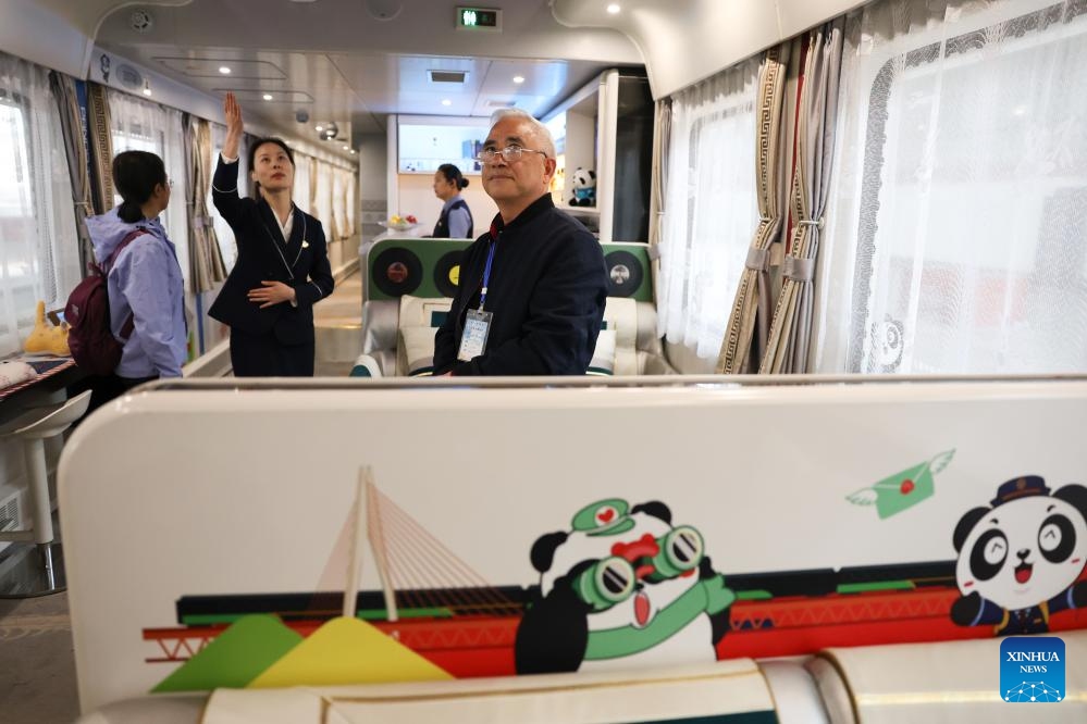 Passengers board a Panda Train at Guiyang railway station in Guiyang, capital of southwest China's Guizhou Province, May 8, 2024. A tourist train, decorated with images, paintings and mascots of the panda and named as Panda Train, linking Guiyang, Xishuangbanna and Laos, departed from Guiyang on Wednesday.(Photo: Xinhua)