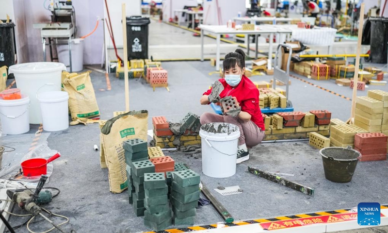 A contestant competes during a construction contest, part of a national vocational skills competition, in Guiyang, capital of southwest China's Guizhou Province, May 8, 2024. A 3-day national vocational skills competition kicked off in Guiyang on Wednesday, including contests of 11 categories, such as vehicle repairing, hair cutting, catering, Chinese cuisine making, etc.(Photo: Xinhua)