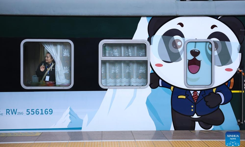 A passenger boards a Panda Train at Guiyang railway station in Guiyang, capital of southwest China's Guizhou Province, May 8, 2024. A tourist train, decorated with images, paintings and mascots of the panda and named as Panda Train, linking Guiyang, Xishuangbanna and Laos, departed from Guiyang on Wednesday.(Photo: Xinhua)