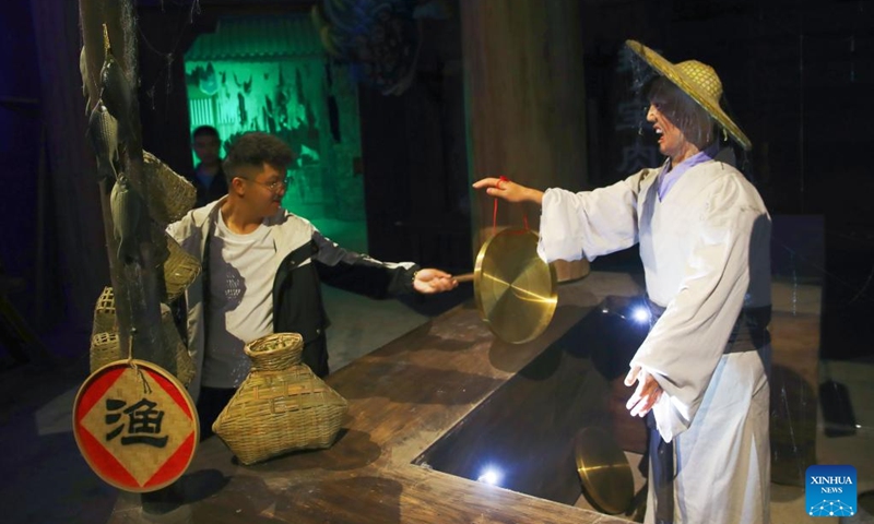 A tourist (L) visits Liaozhaiyuan, a themed park in Zichuan District of Zibo City in east China's Shandong Province, May 8, 2024. The park, which is located in the hometown of the writer of Liaozhai Zhiyi (or Strange Stories from a Chinese Studio), has recently reopened after a renovations and renewal project, attracting visitors to experience the stories and characters of the famous Chinese fiction.(Photo: Xinhua)