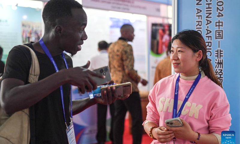 An exhibitor (R) briefs products to a visitor during the China-Africa Economic and Trade Expo (CAETE) in Africa (Kenya) 2024 in Nairobi, Kenya, May 9, 2024. 