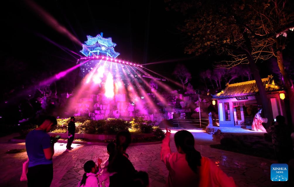 Tourists watch a light show at Liaozhaiyuan, a themed park in Zichuan District of Zibo City in east China's Shandong Province, May 8, 2024. The park, which is located in the hometown of the writer of Liaozhai Zhiyi (or Strange Stories from a Chinese Studio), has recently reopened after a renovations and renewal project, attracting visitors to experience the stories and characters of the famous Chinese fiction.(Photo: Xinhua)