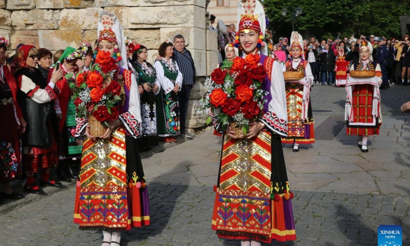Girls in folk costumes present flower baskets at the opening event of Bulgaria's summer tourism season in Nessebar, Bulgaria, on May 17, 2024. The summer tourist season in Bulgaria officially opened on Friday. (Xinhua/Lin Hao)
