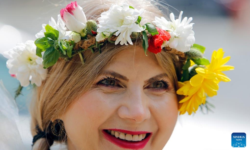A woman wearing handmade traditional clothes poses during an event celebrating Romanian traditional costume in Bucharest, Romania, May 12, 2024. Photo: Xinhua
