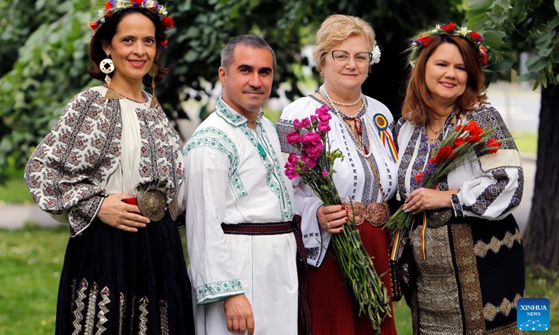 People wearing handmade traditional clothes pose during an event celebrating Romanian traditional costume in Bucharest, Romania, May 12, 2024. Photo: Xinhua