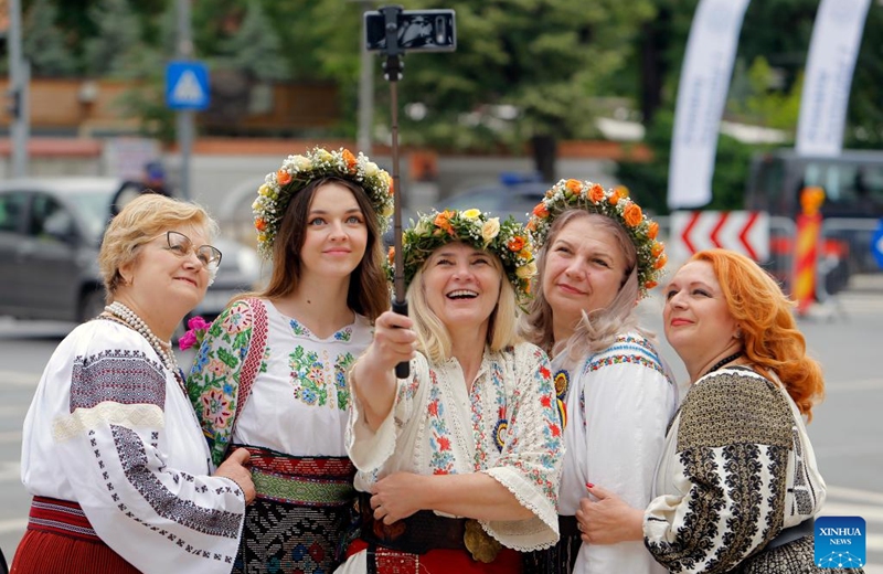 Women wearing handmade traditional clothes pose during an event celebrating Romanian traditional costume in Bucharest, Romania, May 12, 2024. Photo: Xinhua