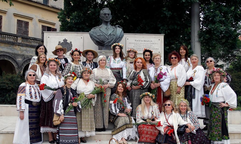 Women wearing handmade traditional clothes pose during an event celebrating Romanian traditional costume in Bucharest, Romania, May 12, 2024. Photo: Xinhua