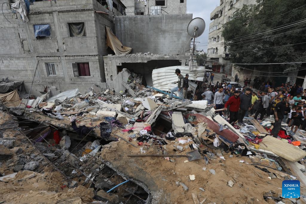 People gather at the site of an Israeli airstrike in the Nuseirat refugee camp, central Gaza Strip, on May 14, 2024. At least 40 people were killed and others injured after midnight Monday by Israeli bombardment in the Nuseirat refugee camp in the central Gaza Strip, the Palestine TV reported.(Photo: Xinhua)