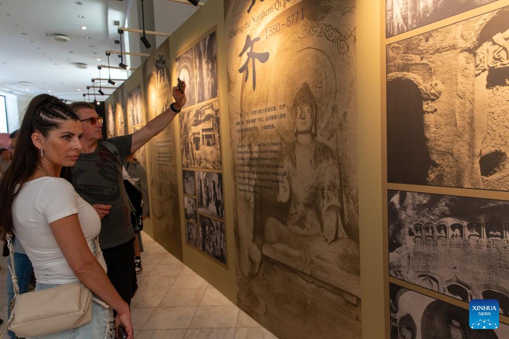 Visitors view the introduction of the art of Chinese grottoes at Zappeion Hall in Athens, Greece, May 11, 2024. The International Touring Exhibition of the Digital Restoration of the Tianlong Mountain Grottoes was held in Athens and attracted many visitors.(Photo: Xinhua)
