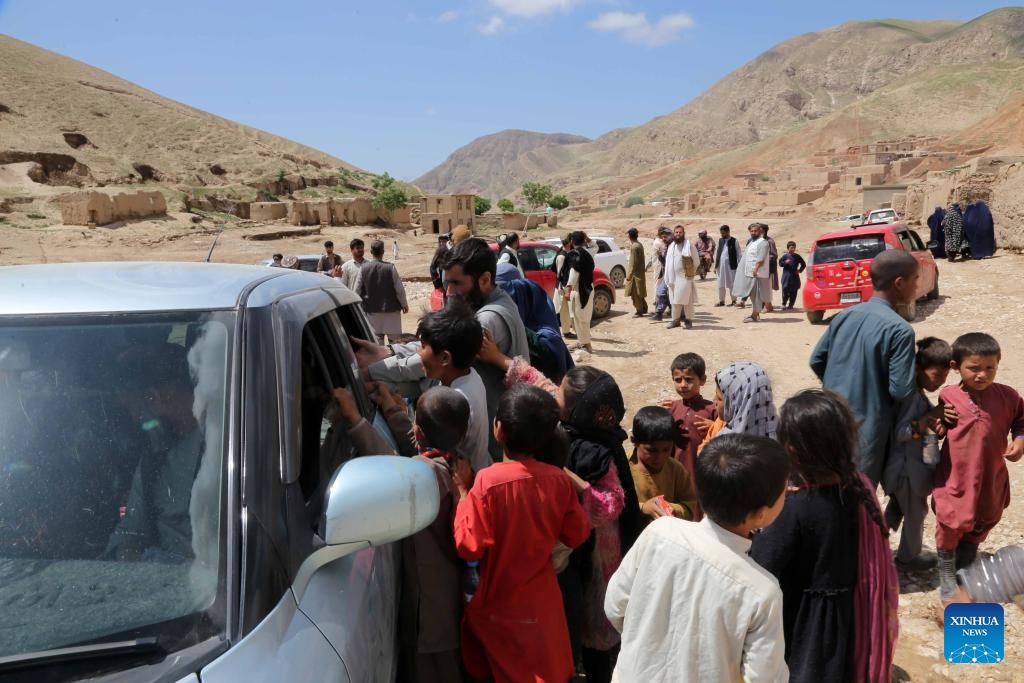 Children crowd beside a car loading flood-relief materials in Borka District, north Afghanistan's Baghlan Province, May 12, 2024. About 40,000 children have lost their homes in north Afghanistan's Baghlan province as heavy downpours and floods lashed the province and other regions on Friday, global charity Save the Children said Monday.(Photo: Xinhua)