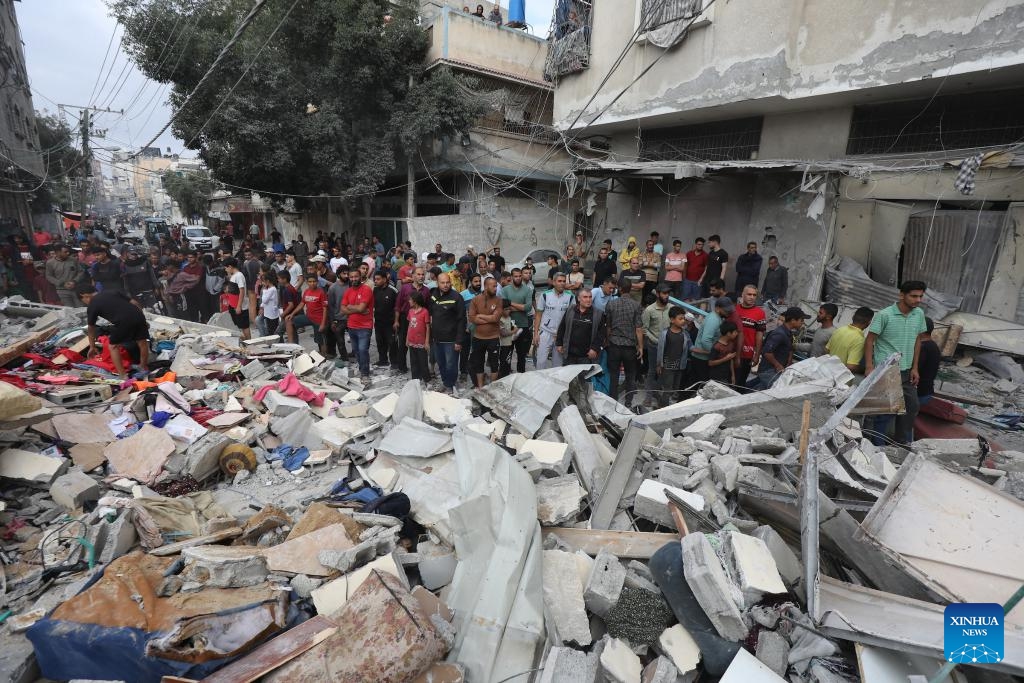People gather at the site of an Israeli airstrike in the Nuseirat refugee camp, central Gaza Strip, on May 14, 2024. At least 40 people were killed and others injured after midnight Monday by Israeli bombardment in the Nuseirat refugee camp in the central Gaza Strip, the Palestine TV reported.(Photo: Xinhua)