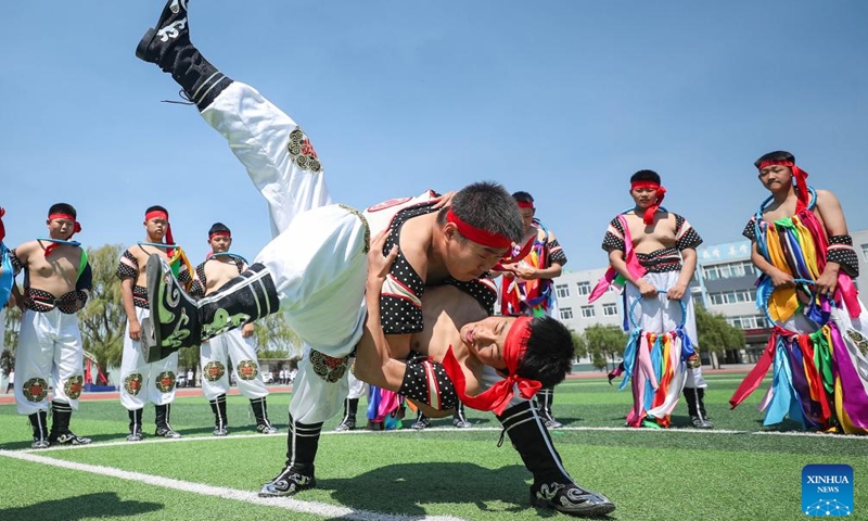 Students practice Mongolian wrestling at a middle school in Fuxin Mongolian Autonomous County, northeast China's Liaoning Province, May 15, 2024. Fuxin has stepped up efforts in protection and inheritance of traditional Mongolian ethnic culture by offering students various lessons such as horse-head fiddle and Mongolian dance, etc. to help bring new vitality to traditional ethnic culture.(Photo: Xinhua)
