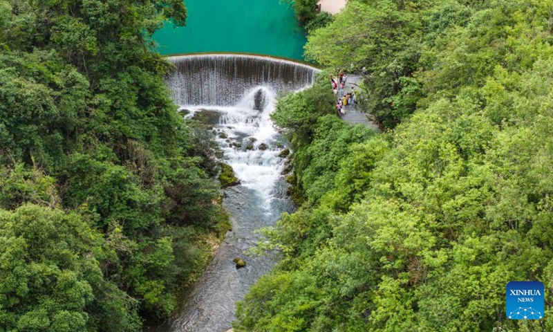 An aerial drone photo taken on May 16, 2024 shows tourists visiting Xiaoqikong scenic area in Libo County, southwest China's Guizhou Province. Situated on the steep mountainside of Guizhou, Libo County has spectacular views in abundance and has seen a boom in tourism in recent years. Photo: Xinhua