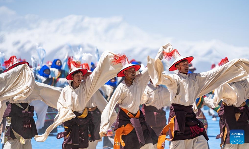 Performers dance at an event celebrating the melting of frozen water of Lake Namtso in southwest China's Xizang Autonomous Region, May 19, 2024. As temperature rises and ice melts, the Lake Namtso will enter its tourism season. Photo: Xinhua