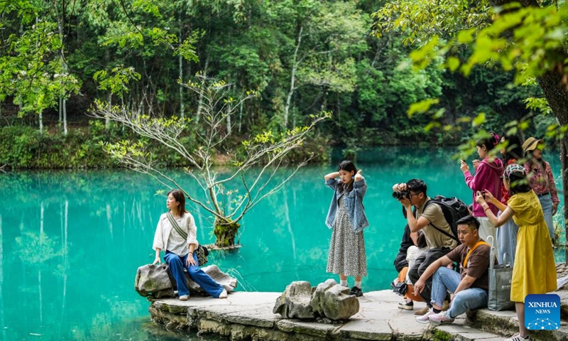 Tourists visit Xiaoqikong scenic area in Libo County, southwest China's Guizhou Province, May 16, 2024. Situated on the steep mountainside of Guizhou, Libo County has spectacular views in abundance and has seen a boom in tourism in recent years. Photo: Xinhua