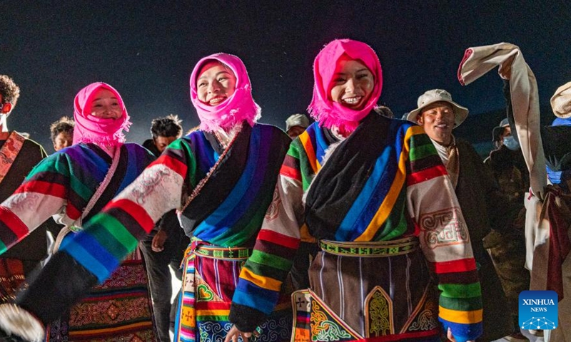 Locals dance at a bonfire party celebrating the melting of frozen water of Lake Namtso in southwest China's Xizang Autonomous Region, May 18, 2024. As temperature rises and ice melts, the Lake Namtso will enter its tourism season. Photo: Xinhua
