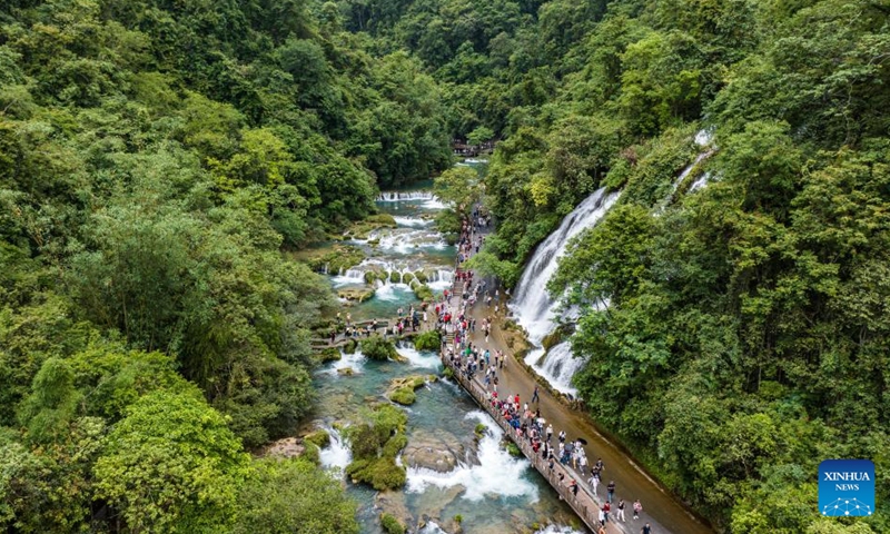 An aerial drone photo taken on May 16, 2024 shows tourists visiting Xiaoqikong scenic area in Libo County, southwest China's Guizhou Province. Situated on the steep mountainside of Guizhou, Libo County has spectacular views in abundance and has seen a boom in tourism in recent years. Photo: Xinhua
