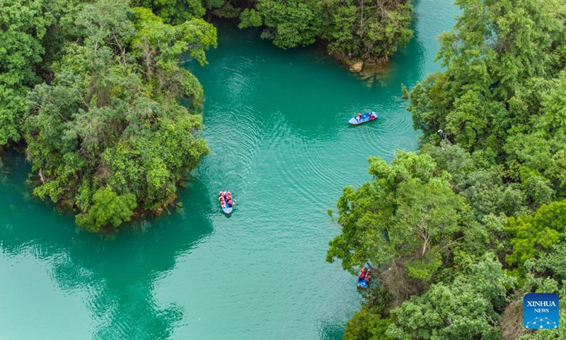 An aerial drone photo taken on May 16, 2024 shows tourists visiting Xiaoqikong scenic area in Libo County, southwest China's Guizhou Province. Situated on the steep mountainside of Guizhou, Libo County has spectacular views in abundance and has seen a boom in tourism in recent years. Photo: Xinhua