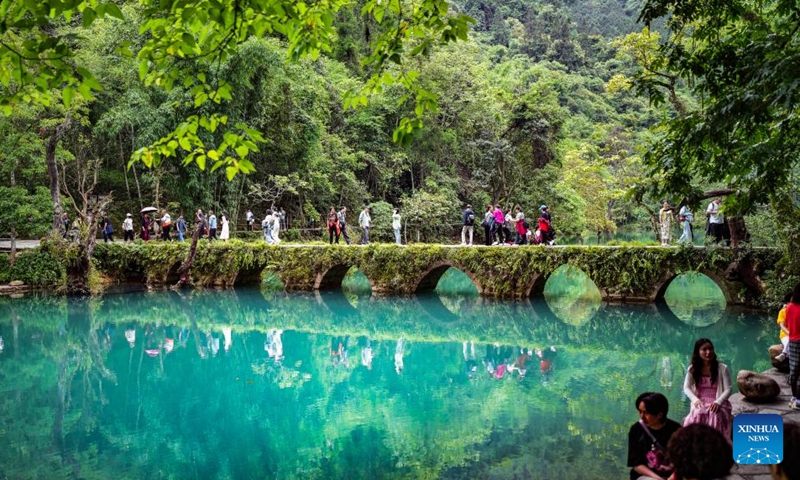 Tourists visit Xiaoqikong scenic area in Libo County, southwest China's Guizhou Province, May 16, 2024. Situated on the steep mountainside of Guizhou, Libo County has spectacular views in abundance and has seen a boom in tourism in recent years. Photo: Xinhua
