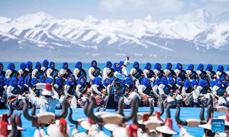 Performers dance at an event celebrating the melting of frozen water of Lake Namtso in southwest China's Xizang Autonomous Region, May 19, 2024. As temperature rises and ice melts, the Lake Namtso will enter its tourism season. Photo: Xinhua